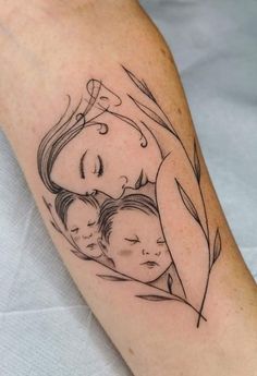 a woman's arm with a drawing of two children and a leaf on it