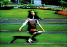 a blurry image of a person running in the grass