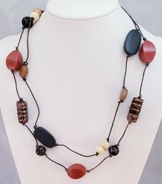 This is a Chico's Brand Red Moon Boho Mixed Beaded Venetian Glass Bib Necklace. The metal extender is a silver tone metal. The necklace measures 25" at the longest, it is adjustable and weighs 1.5 oz. It is NWT N17 Items are shipped from a smoke-free home. Photos are part of the listing so PLEASE look at all pictures. And if an item is Sterling Silver it may tarnish in time, I suggest you buy a Polishing Cloth (one brand is called SUNSHINE CLOTH) and take care of it, Wearing it in water will als Brown Necklaces With Black Beads For Beach, Adjustable Brown Necklace With Black Beads, Casual Red Beaded Chain Jewelry, Bohemian Red Necklace With Black Beads, Casual Wooden Beaded Necklaces For Jewelry Making, Casual Wooden Beads Necklace For Jewelry Making, Colorful Glass Bead Necklaces, Adjustable Long Necklace With Large Beads For Festivals, Brown Long Necklace With Colorful Beads For Gift