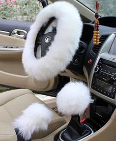 the interior of a car is decorated with white fur and black trims, including steering wheel