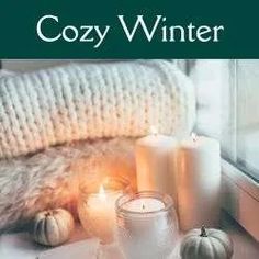 cozy winter with candles, books and other items on a window sill next to a blanket