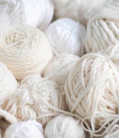 several balls of white yarn are piled on top of each other