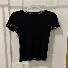 Cute Black Ribbed Tee With White Trimmed Lettuce Hem. Thrifted, Washed But Never Worn By Me. Super Cute Closet Basic! Black Ribbed Fitted Tops, Black Fitted Ribbed Top, Black Fitted Knit Top With Short Sleeves, Black Fitted Knit Top Short Sleeve, Black Fitted Knit Top For Spring, Black Cotton Fitted Knit Top, Black Fitted Cotton Knit Top, Fitted Black Crew Neck Knit Top, Black Ribbed Fitted T-shirt