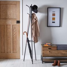 a coat rack with an umbrella and hat on it