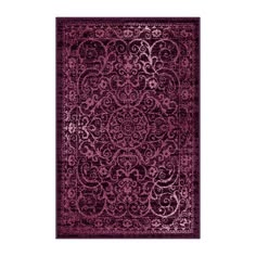 a purple rug with an intricate design on the front and back side, in various colors