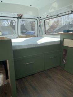 the inside of a camper with two beds and drawers