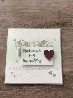 a card with a heart on it and the words,'happy valentine's day'written in german