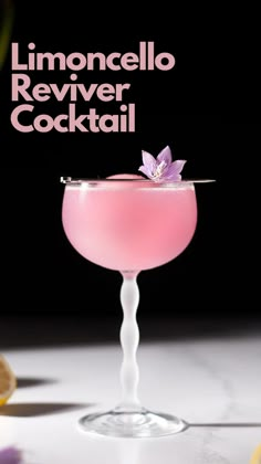 a pink cocktail sitting on top of a table