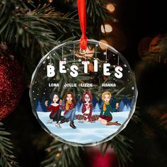 a glass ornament with the words besties hanging on a christmas tree branch