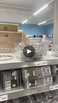 a store shelf filled with lots of plastic containers and boxes on top of each other