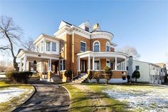 a large brick house sitting on top of a snow covered field