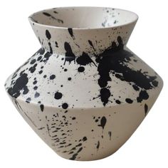 a black and white vase with spots on it