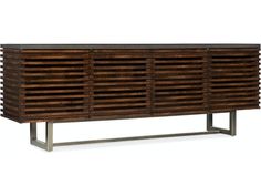 a wooden sideboard with metal legs and shutters on the front, against a white background