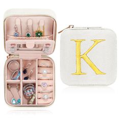 a white case filled with jewelry next to a monogrammed initial letter k bag