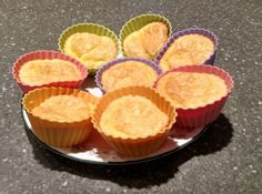 several cupcakes are on a plate and ready to be baked in the oven