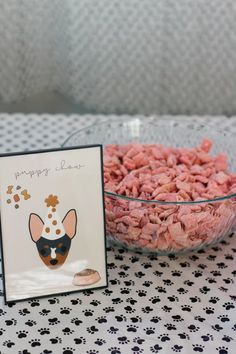 a bowl of dog treats next to a card