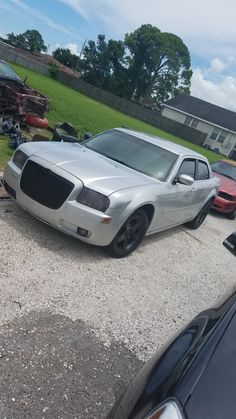 two cars parked in a lot next to each other