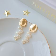 - NATALI -  These beauties are not only sophisticated but also versatile enough to rock all day, every day. Their unique asymmetric design is sure to make a statement whether you're running errands or celebrating a special moment. Indulge yourself in the effortless elegance of these earrings. ✨ //Materials// ♥ 4-5mm rice shape freshwater pearls ♥ 14k gold-filled accents (gold on brass) ♥ 14k gold vermeil post (gold on sterling silver) //Dimension// Length: 3.2cm Pearl Drop: 2cm Disc Width: 1.2cm **Feel free to ask me anything if you have doubts //Freshwater Pearls// We meticulously choose cultured pearls from both oysters and freshwater mussels for our creations. Given the delicate nature of pearls, it's essential to handle them with care and affection. //Gold Filled// Distinguishable from Modern Gold Plated Earrings For Wedding, Modern Gold Pearl Earrings For Wedding, Modern Yellow Gold Pearl Earrings For Wedding, Modern Gold Bridal Earrings Gift, Pearl Dangle Earrings, Disc Earrings, Pearl Earrings Dangle, Precious Gemstones, Cultured Pearls