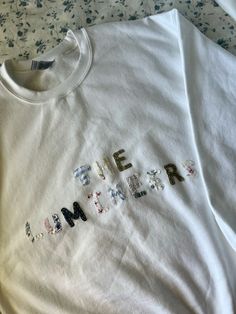 a white t - shirt with the word emer written in small letters on it