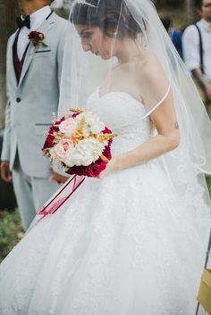 a woman in a wedding dress holding a bouquet