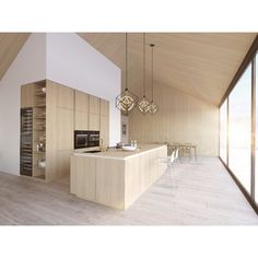 a large kitchen with wooden floors and white walls