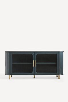 an entertainment unit with two doors and gold legs