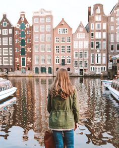 a woman standing on the edge of a body of water