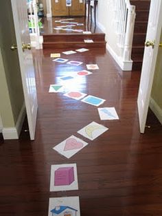 the hallway is decorated with paper cutouts on the floor, and there are stairs leading up to the front door