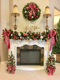 a fireplace decorated for christmas with wreaths and decorations