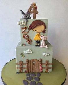 a birthday cake with a girl and cat on top