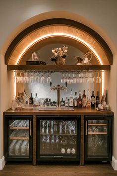 a wine bar with lots of bottles and glasses on the top shelf in front of it