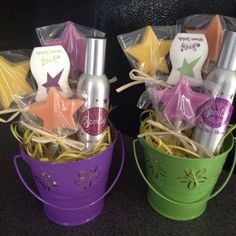 two buckets filled with star shaped items on top of a black table next to each other