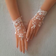 Elegant ivory or gray lace bridal gloves Wanting to feel yourself unique for you Each custom-made suitable This elegant glove is the perfect complement to your dress for a wedding or any celebration. Thank you for visiting my shop GlovesByJana®2013 Elegant Lace Bridal Accessories For Bridal Shower, Elegant Fingerless Bridal Accessories For Wedding, White Fingerless Bridal Accessories, Cream Lace Bridal Accessories For Party, Elegant Handmade Lace For Wedding, Elegant Handmade Wedding Lace, Elegant Fingerless Bridal Accessories For Party, Elegant Bridal Accessories With Lace Trim For Party, Elegant Bridal Accessories With Delicate Lace For Party