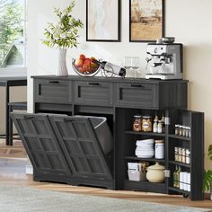 a kitchen area with an open cabinet and coffee maker on the counter, next to a potted plant