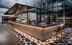 an indoor bar with black and white checkered flooring on the walls, along with lots of lights