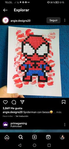 someone is holding up a piece of art that looks like spiderman from the video game