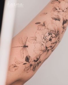 a woman's arm with flowers on it