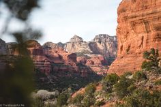 the mountains are covered with red rocks and trees