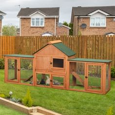 a large wooden chicken coop in the yard