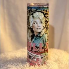 a candle with an image of dolly on it sitting on a white furnishing