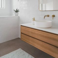 a bathroom with a sink, mirror and bathtub