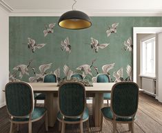 a dining room table and chairs with birds on the wall behind it, in front of a green background