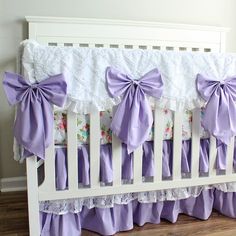 the crib is adorned with purple bows