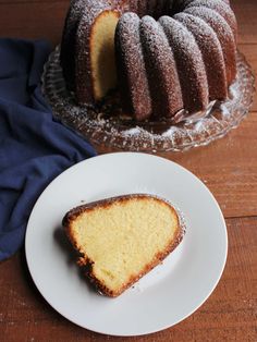 a bundt cake sitting on top of a white plate next to a piece of cake