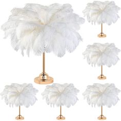 six white ostrich feathers on gold base lamps, each with a light bulb