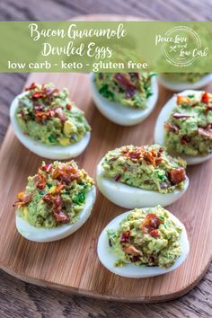 deviled eggs with bacon and guacamole on a wooden cutting board, ready to be eaten