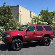 a red truck parked in a parking lot