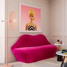 a living room filled with furniture and a pink couch next to a painting on the wall