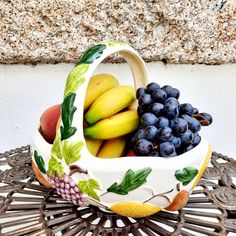 a bowl with fruit in it sitting on a table