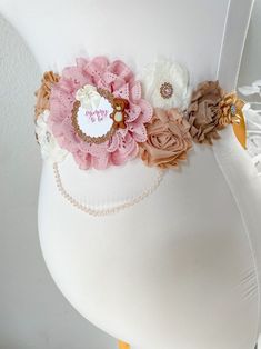 a pregnant belly is adorned with flowers and pearls